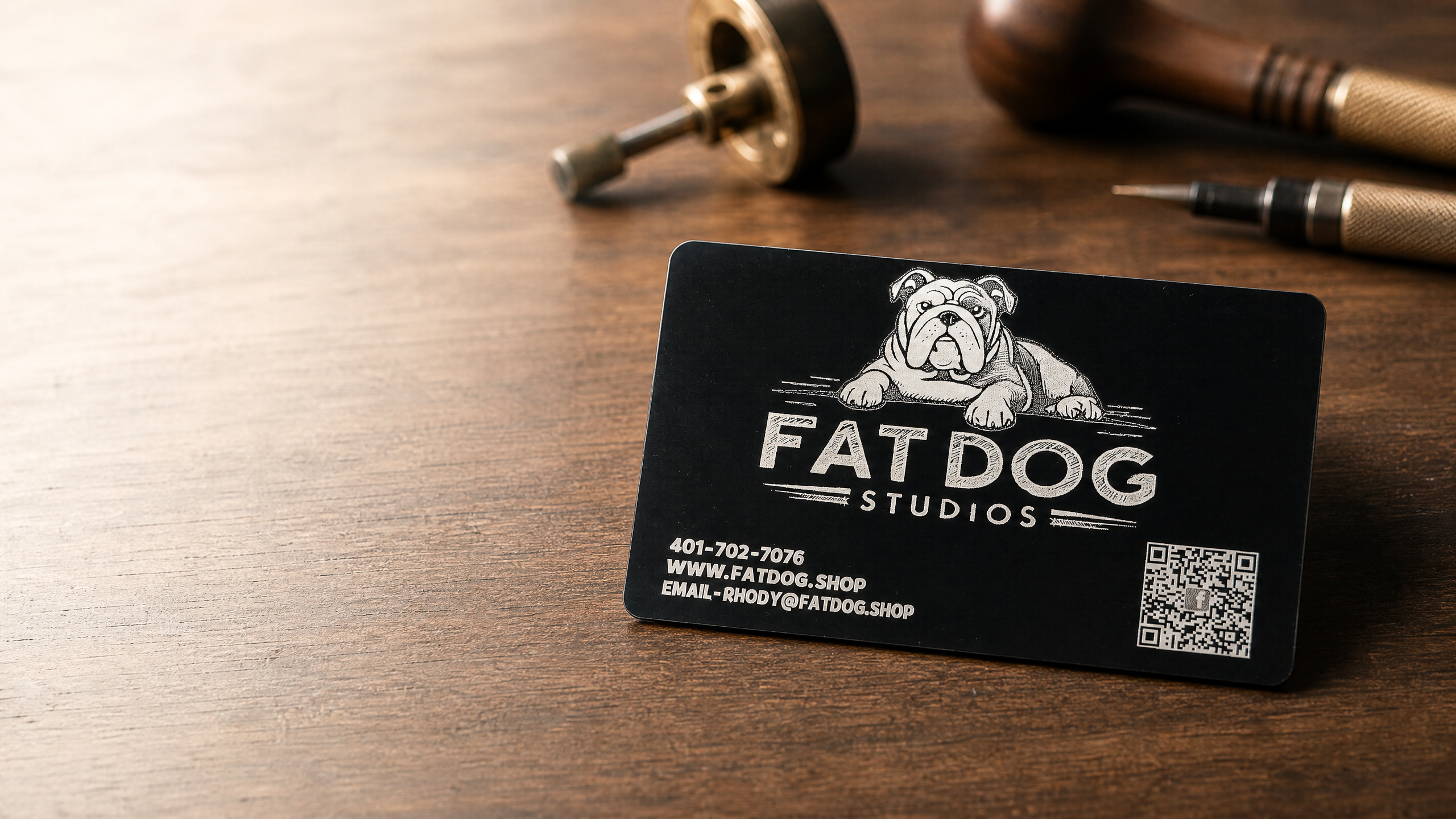 Fat Dog Studios hero showing engraved work on a warm walnut workbench